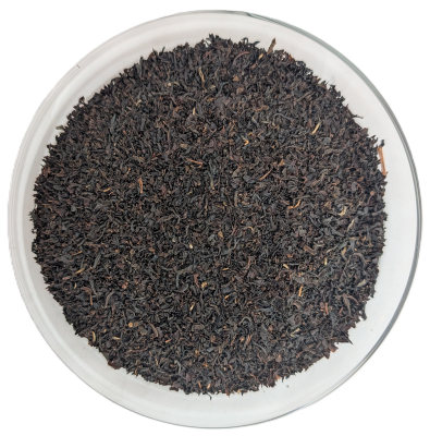 Assam Broken Schwarztee mit Goldspitzen – feingebrochenes, dunkelbraunes Blatt mit goldenen Spitzen in einer Schale.