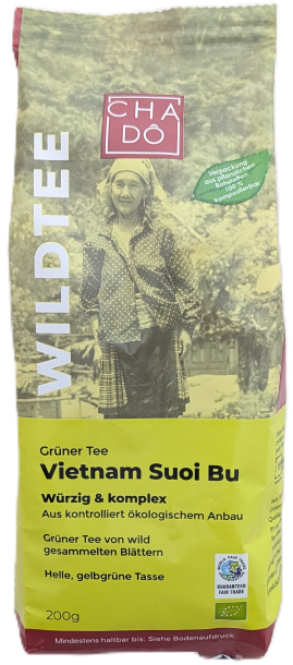 Cha Dô Wildtee Bio Vietnam Suoi Bu Grüner Tee Verpackung in Lindgrün mit Bild einer traditionell gekleideten Frau aus Vietnam. Bildbeschreibung: Tee-Verpackung von Cha Dô aus der Wildtee-Reihe, mit lindgrünem Akzent und Schwarz-Weiß-Foto einer vietnamesis